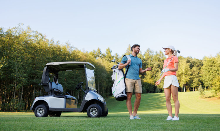 Dynamic Golfers with Clubs and Cart in View