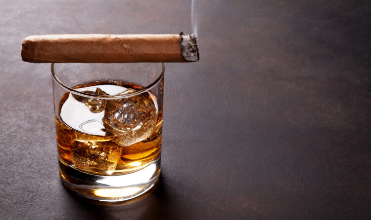 Whiskey with ice and cigar. With copy space